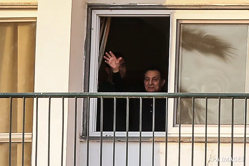 Former Egyptian President Hosni Mubarak waves to supporters during a celebration to mark his 87th birthday, outside Maadi military hospital, near Cairo on May 4, 2015. An Egyptian legal authority on Monday ruled in favor...