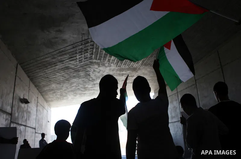 Palestinian protesters from the East Jerusalem village of al-Zaim, wave Palestinian flags as they confront Israeli Border Police during a protest demanding the opening of the only gate in the separated barrier leading fr...