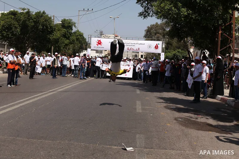 Palestinians take part in a marathon to mark the International Thalassemia Day Gaza city, May 9, 2015. Thalassemia is a genetic disease of the blood that patients cannot produce enough hemoglobin, the substance in red bl...