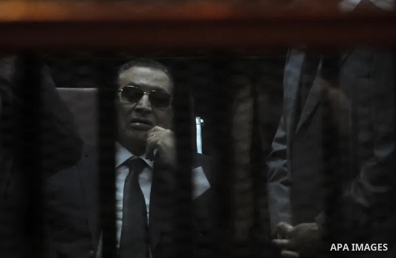 Ousted Egyptian president Hosni Mubarak sits in the defendant s cage during his verdict hearing in a retrial for embezzlement on May 9, 2015 in the capital Cairo. The Egyptian court sentenced Mubarak and his two sons to...
