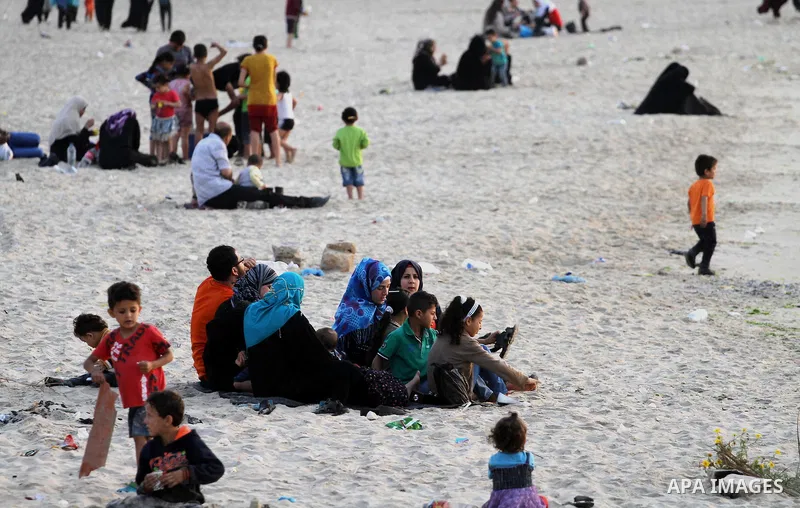 Palestinians enjoy their time during sunset at the beach of Gaza sea on May 9, 2015. Photo by Mohammed Asad