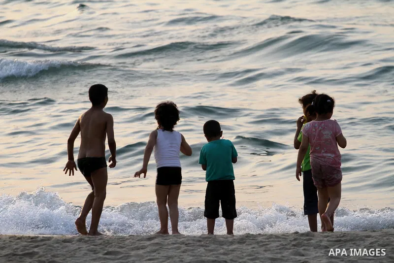 Palestinian children enjoy their time during sunset at the beach of Gaza sea on May 9, 2015. Photo by Mohammed Asad