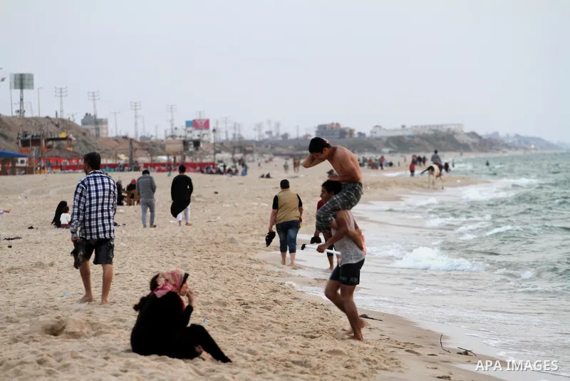 Palestinians enjoy their time during sunset at the beach of Gaza sea on May 9, 2015. Photo by Mohammed Asad