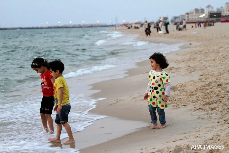 Palestinian children enjoy their time during sunset at the beach of Gaza sea on May 9, 2015. Photo by Mohammed Asad