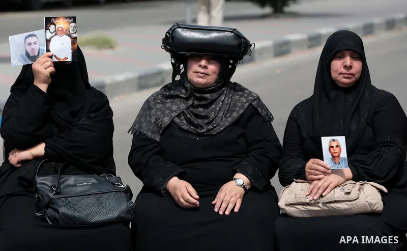Palestinian families of martyrs take part a protest to demand their rights, in front of the headquarters of the Council of Ministers in Gaza city, on May 12, 2015. Photo by Yasser Qudih