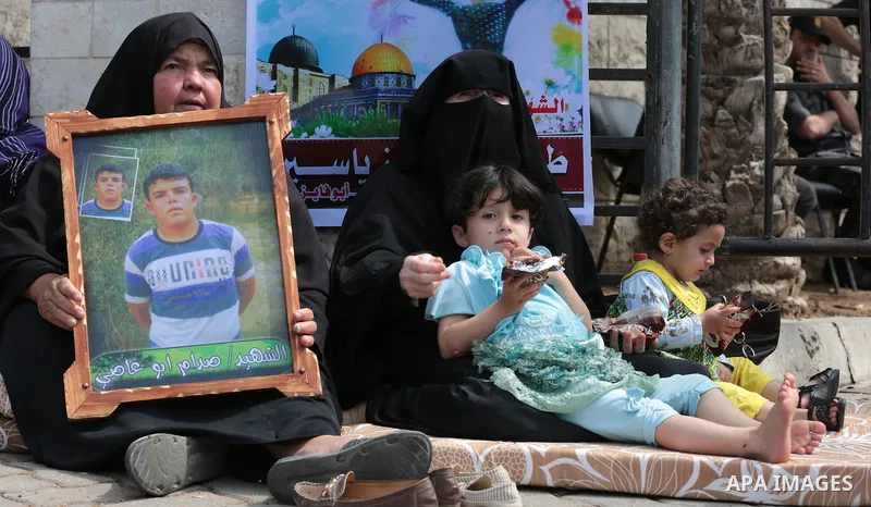 Palestinian families of martyrs take part a protest to demand their rights, in front of the headquarters of the Council of Ministers in Gaza city, on May 12, 2015. Photo by Yasser Qudih