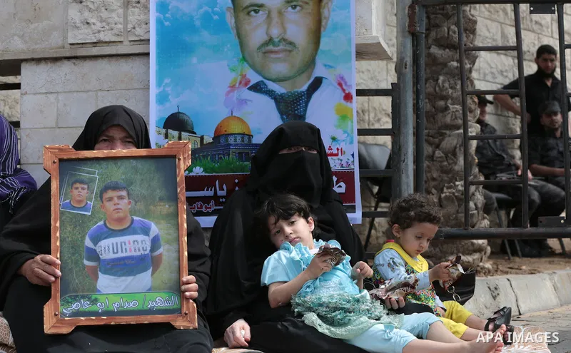 Palestinian families of martyrs take part a protest to demand their rights, in front of the headquarters of the Council of Ministers in Gaza city, on May 12, 2015. Photo by Yasser Qudih