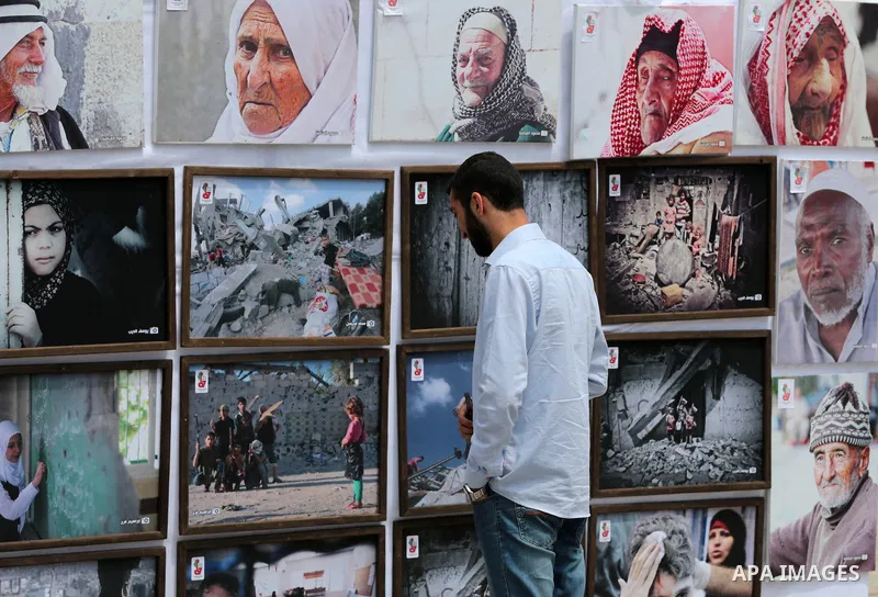 Palestinians take part in a photo exhibition ahead of the commemorations of the 67th anniversary of the ''Nakba'', in Gaza city on May 12, 2015. ''Nakba'' means in Arabic ''catastrophe'' in reference to the birth of the...