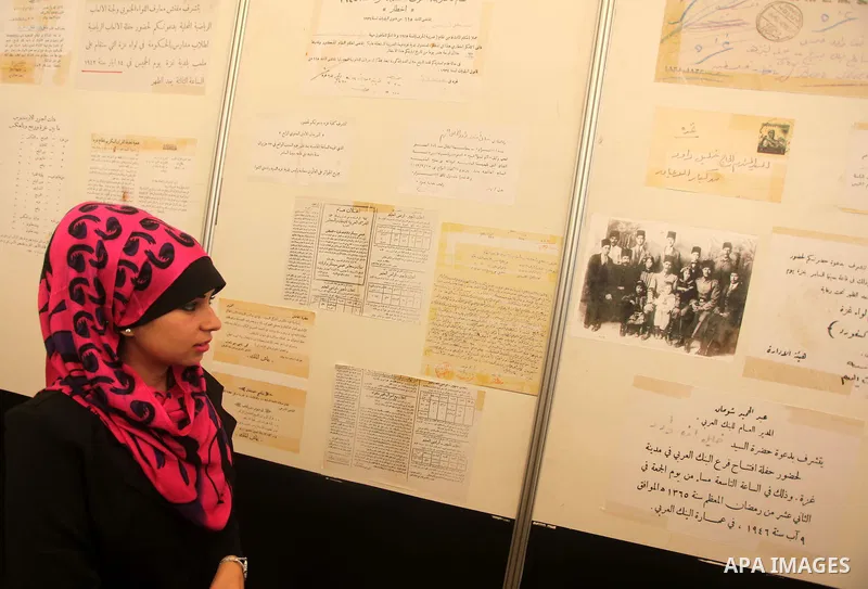 A Palestinian woman reads an old document that written before the Nakba, during a historical documents gallery in Gaza city on May 14, 2015. ''Nakba'' means in Arabic ''catastrophe'' in reference to the birth of the stat...