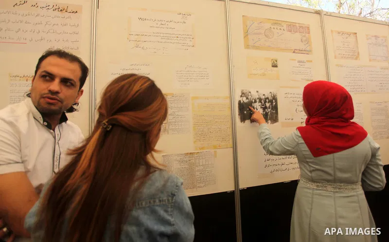 Palestinians read old documents that written before the Nakba, during a historical documents gallery in Gaza city on May 14, 2015. ''Nakba'' means in Arabic ''catastrophe'' in reference to the birth of the state of Israe...