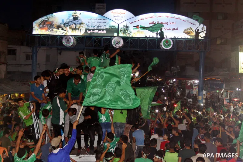 Palestinian members of al-Shijaiyah football club with their fans, celebrate winning Gaza league championship, near the rubbles of houses which where destroyed during the recent Israeli war in the summer of 2014, at al-S...