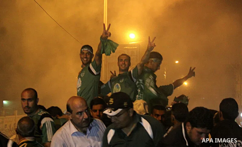 Palestinian members of al-Shijaiyah football club with their fans, celebrate winning Gaza league championship, near the rubbles of houses which where destroyed during the recent Israeli war in the summer of 2014, at al-S...