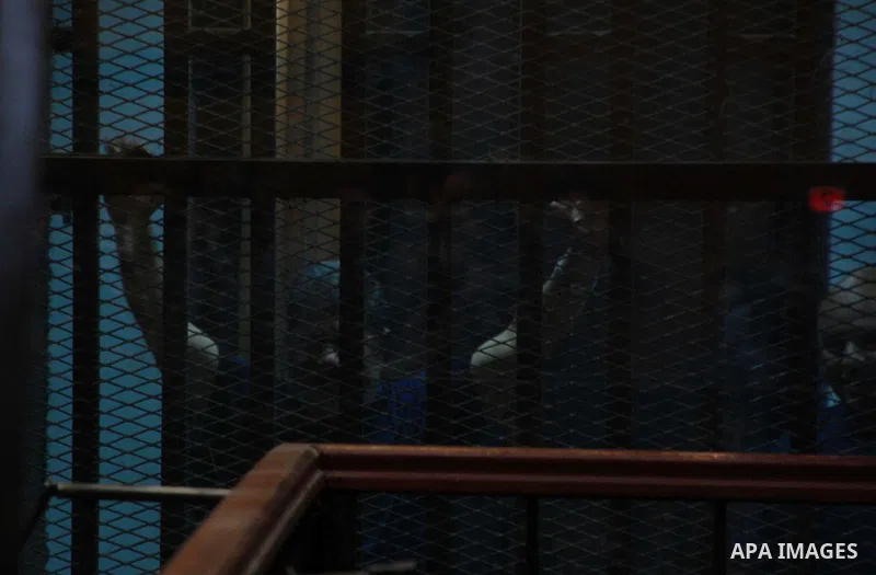 Former Egyptian President Mohamed Mursi waves as he enters for his trial with other Muslim Brotherhood members at a court in the outskirts of Cairo, May 16, 2015. An Egyptian court on Saturday sought the death penalty fo...