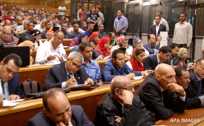 Egyptians attend the trial of former Egyptian President Mohamed Mursi and other Muslim Brotherhood members at a court in the outskirts of Cairo, Egypt May 16, 2015. An Egyptian court on Saturday sought the death penalty...