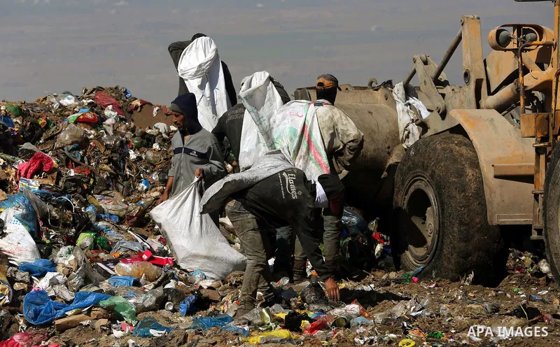 Palestinians collect rubbish for re-sale at a dump site in the village of Johar a-Deek near central Gaza Strip, on May 16, 2015. Photo by Yasser Qudih