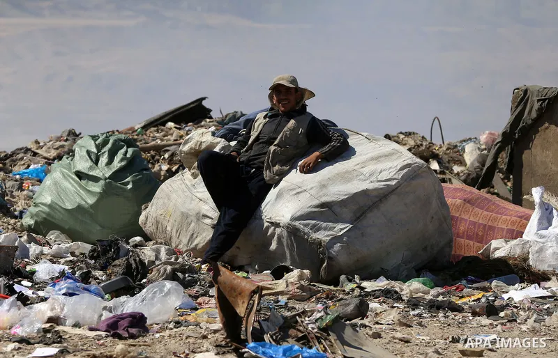 Palestinians collect rubbish for re-sale at a dump site in the village of Johar a-Deek near central Gaza Strip, on May 16, 2015. Photo by Yasser Qudih