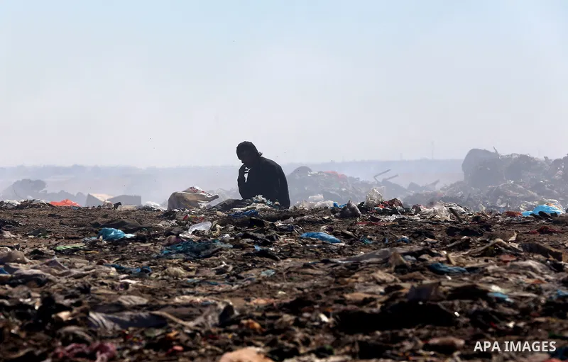 Palestinians collect rubbish for re-sale at a dump site in the village of Johar a-Deek near central Gaza Strip, on May 16, 2015. Photo by Yasser Qudih