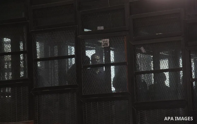 Egyptian radical Islamist Mohammed al-Zawahiri, the brother of Al-Qaeda chief Ayman al-Zawahiri, sits in the defendants cage during his trial, at a court in Cairo on May 17, 2015. Photo by Amr Sayed