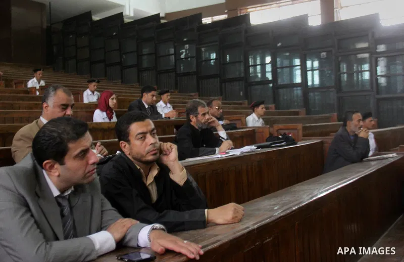 Egyptian radical Islamist Mohammed al-Zawahiri, the brother of Al-Qaeda chief Ayman al-Zawahiri, sits in the defendants cage during his trial, at a court in Cairo on May 17, 2015. Photo by Amr Sayed