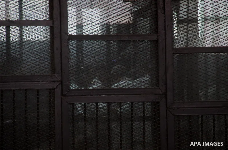 Egyptian radical Islamist Mohammed al-Zawahiri, the brother of Al-Qaeda chief Ayman al-Zawahiri, sits in the defendants cage during his trial, at a court in Cairo on May 17, 2015. Photo by Amr Sayed