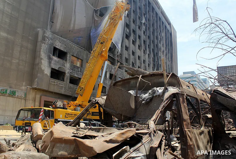 Egyptian workers use a crane to pull down National Democratic Party building, in Cairo on May 17, 2015. Last month, the Egyptian cabinet made a decision to pull down the headquarters of the currently-dismantled National...