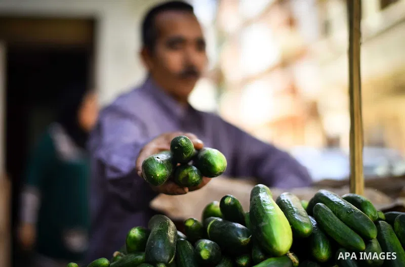 An Egyptian man sells vegetables, at a street market in Ad Duqqi district, near Cairo on May 19, 2015. Egypt suspended a capital gains tax on Monday, sending shares soaring after a months-long downturn in which investors...