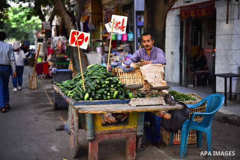 An Egyptian man sells vegetables, at a street market in Ad Duqqi district, near Cairo on May 19, 2015. Egypt suspended a capital gains tax on Monday, sending shares soaring after a months-long downturn in which investors...