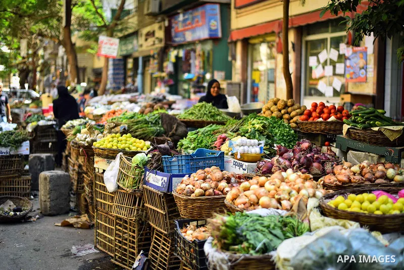 An Egyptian woman sells vegetables, at a street market in Ad Duqqi district, near Cairo on May 19, 2015. Egypt suspended a capital gains tax on Monday, sending shares soaring after a months-long downturn in which investo...