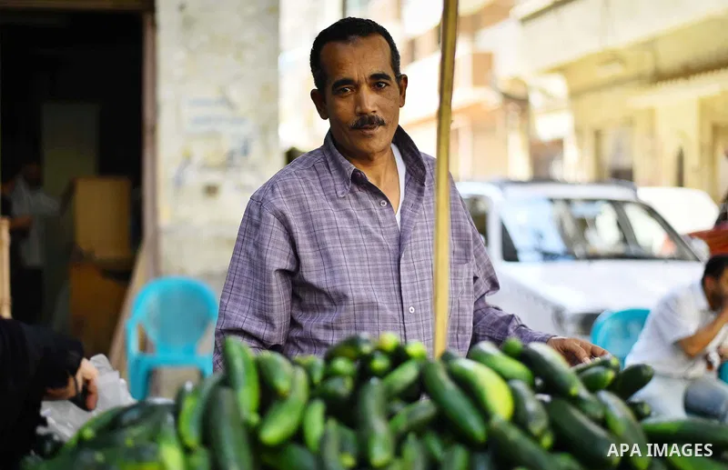 An Egyptian man sells vegetables, at a street market in Ad Duqqi district, near Cairo on May 19, 2015. Egypt suspended a capital gains tax on Monday, sending shares soaring after a months-long downturn in which investors...