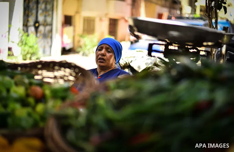 An Egyptian woman sells vegetables, at a street market in Ad Duqqi district, near Cairo on May 19, 2015. Egypt suspended a capital gains tax on Monday, sending shares soaring after a months-long downturn in which investo...