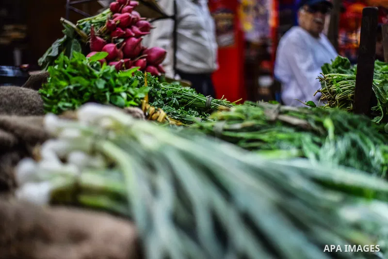 An Egyptian man sells vegetables, at a street market in Ad Duqqi district, near Cairo on May 19, 2015. Egypt suspended a capital gains tax on Monday, sending shares soaring after a months-long downturn in which investors...