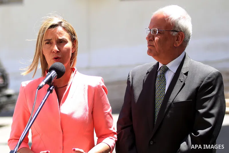 European Union foreign policy chief Federica Mogherini (L) and Saeb Erekat, Chief Palestinian negotiator, speak to the press following her meeting with Palestinian President Mahmoud Abbas at his headquarters in the West...