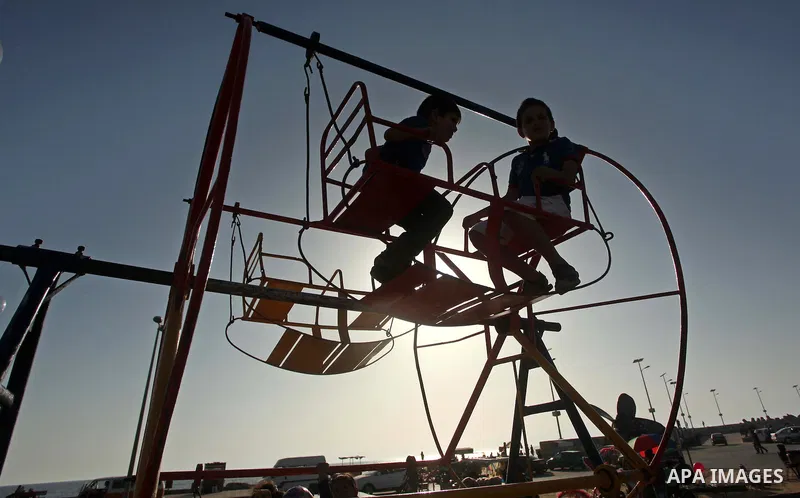 Palestinians enjoy a day on a warm day in the Mediterranean Sea beach, off the coast of Gaza City on May 20, 2015. Photo by Ashraf Amra