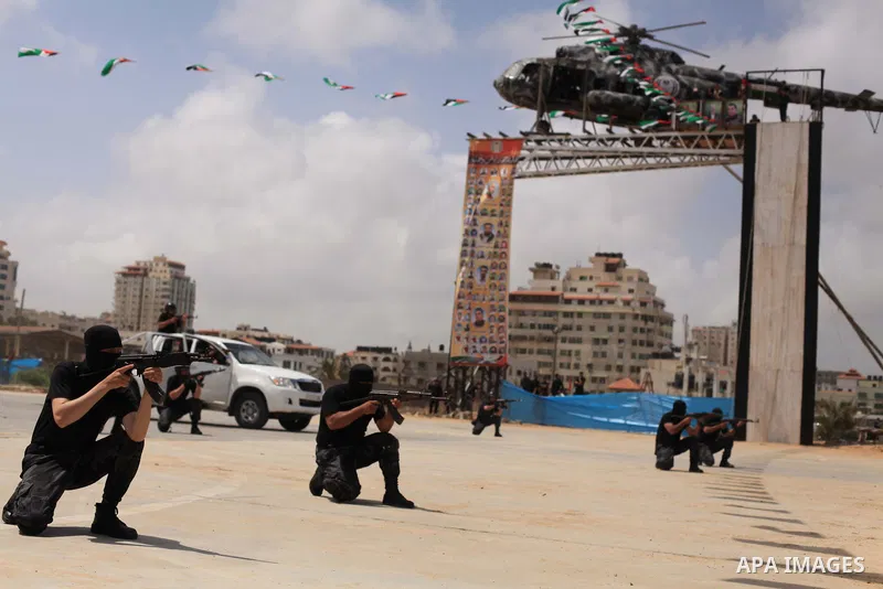 Palestinian security forces show their skills during a military training graduation ceremony in Gaza City on May 21, 2015. Photo by Ashraf Amra