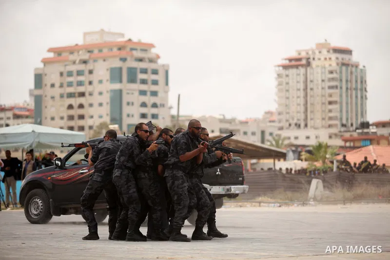 Palestinian security forces show their skills during a military training graduation ceremony in Gaza City on May 21, 2015. Photo by Ashraf Amra