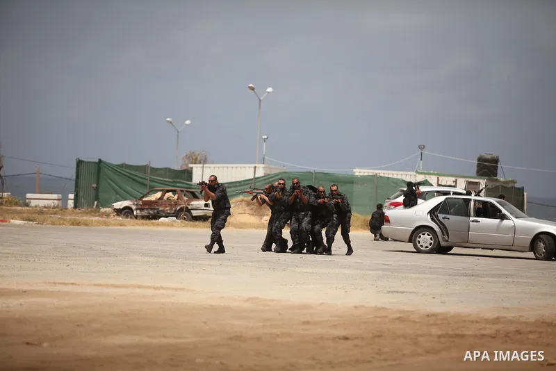 Palestinian security forces show their skills during a military training graduation ceremony in Gaza City on May 21, 2015. Photo by Ashraf Amra