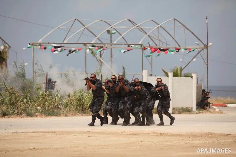 Palestinian security forces show their skills during a military training graduation ceremony in Gaza City on May 21, 2015. Photo by Ashraf Amra