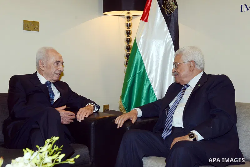 Palestinian President Mahmoud Abbas meets with former Israeli President Shimon Peres at the opening day of the World Economic Forum (WEF) on the Middle East and North Africa, in the Dead Sea resort of Shuneh, west of the...