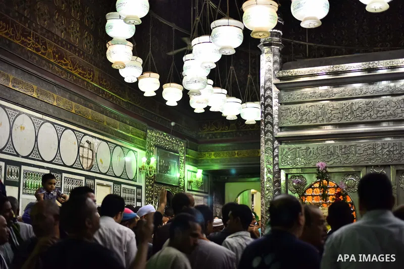 Egyptian worshippers attend a Mawlid al-Hussein, a religious celebration marking the birthday of the grandson of the Prophet Muhammad, in Cairo, Egypt, Tuesday, May 22, 2015. The celebration is one of the largest in Egyp...