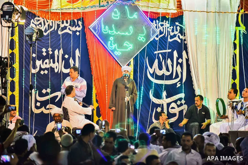 Egyptian worshippers attend a Mawlid al-Hussein, a religious celebration marking the birthday of the grandson of the Prophet Muhammad, in Cairo, Egypt, Tuesday, May 22, 2015. The celebration is one of the largest in Egyp...