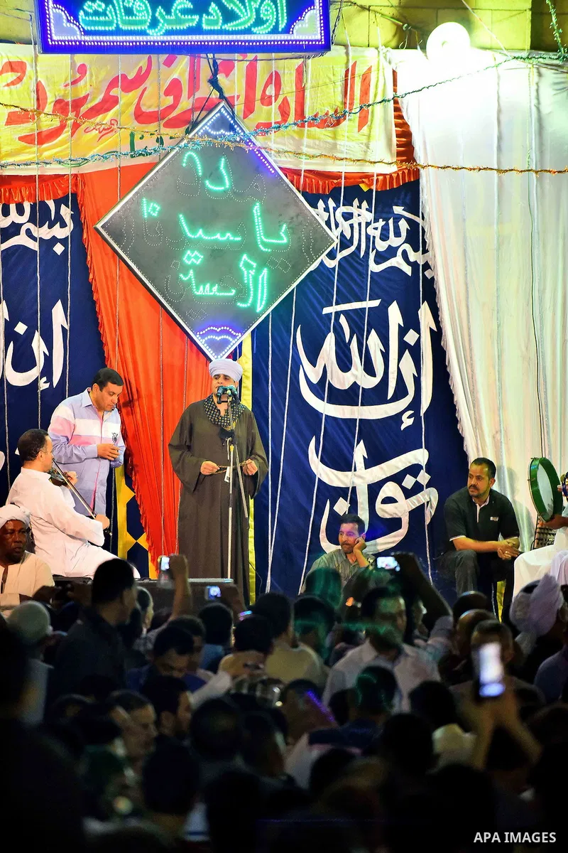 Egyptian worshippers attend a Mawlid al-Hussein, a religious celebration marking the birthday of the grandson of the Prophet Muhammad, in Cairo, Egypt, Tuesday, May 22, 2015. The celebration is one of the largest in Egyp...