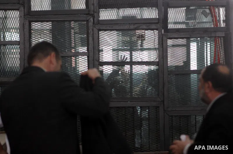 Muslim Brotherhood's Supreme Guide Mohamed Badie reacts with other brotherhood members at a court in the outskirts of Cairo, Egypt May 23, 2015. Photo by Stranger