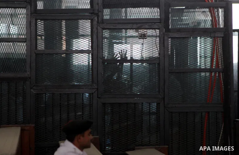 Muslim Brotherhood's Supreme Guide Mohamed Badie reacts with other brotherhood members at a court in the outskirts of Cairo, Egypt May 23, 2015. Photo by Stranger