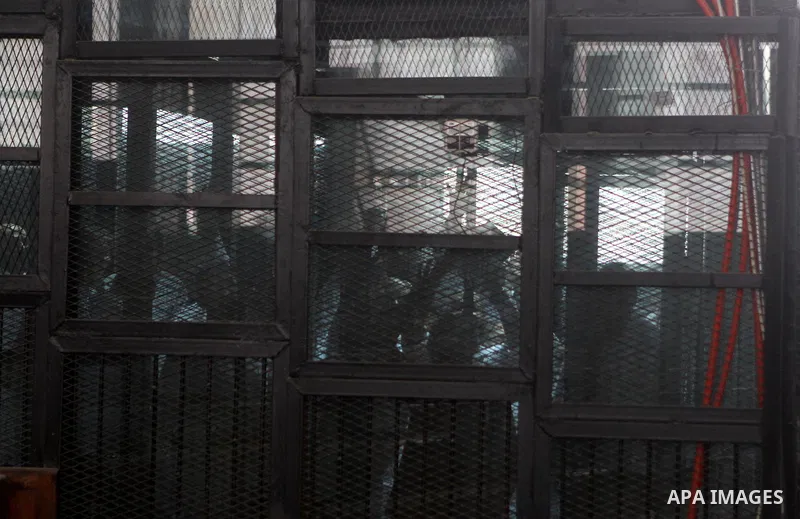 Muslim Brotherhood's Supreme Guide Mohamed Badie reacts with other brotherhood members at a court in the outskirts of Cairo, Egypt May 23, 2015. Photo by Stranger