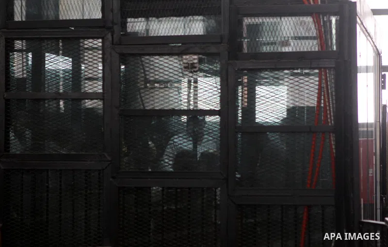 Muslim Brotherhood's Supreme Guide Mohamed Badie reacts with other brotherhood members at a court in the outskirts of Cairo, Egypt May 23, 2015. Photo by Stranger
