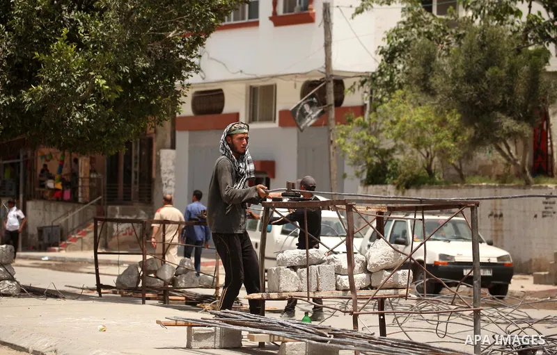 Palestinian men work amid the rubble of houses which were destroyed during the 50-day war between Israel and Hamas militants in the summer of 2014, in the Eastern Gaza City Shujaiya neighbourhood, on May 23, 2015. Photo...
