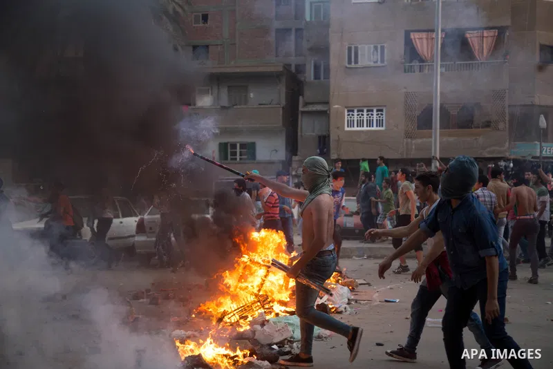 Egyptian protesters participate in a demonstration against the military regime on the outskirts of Cairo, Egypt, on May 23, 2015. Cairo Criminal Court on Saturday postponed to July 27 the trial of ousted Islamist Egyptia...