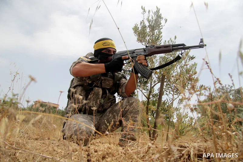 A masked Palestinian militant of al-Aqsa Martyrs' Brigades, a group linked to the Fatah movement, demonstrates his skills during a training in in central Gaza Strip on May 24, 2015. Photo by Nidal Alwaheidi