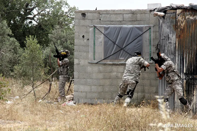 Masked Palestinian militants of al-Aqsa Martyrs' Brigades, a group linked to the Fatah movement, demonstrate their skills during a training in in central Gaza Strip on May 24, 2015. Photo by Nidal Alwaheidi
