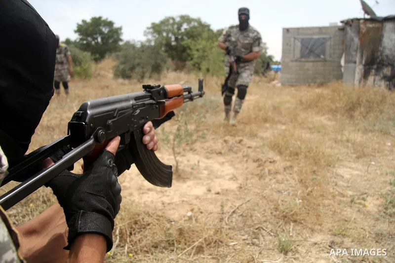Masked Palestinian militants of al-Aqsa Martyrs' Brigades, a group linked to the Fatah movement, demonstrate their skills during a training in in central Gaza Strip on May 24, 2015. Photo by Nidal Alwaheidi